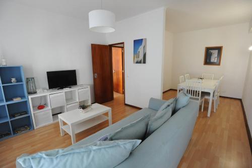 a living room with a blue couch and a table at Lagos Central Apartments Ap 3 in Lagos
