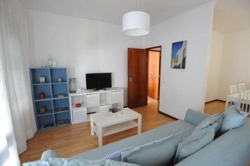 a living room with a blue couch and a table at Lagos Central Apartments Ap 3 in Lagos
