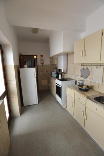 a kitchen with white appliances and a white refrigerator at Lagos Central Apartments Ap 3 in Lagos