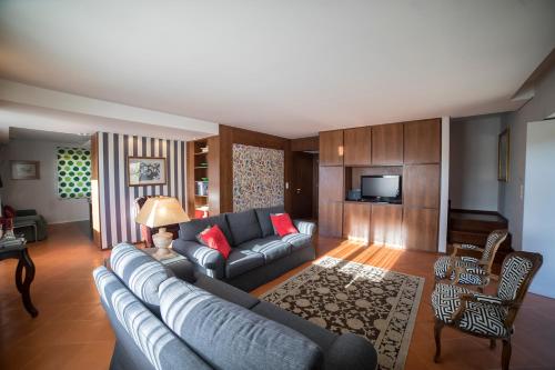 a living room with a couch and a tv at Quinta da Casa Nova in Santo Tirso