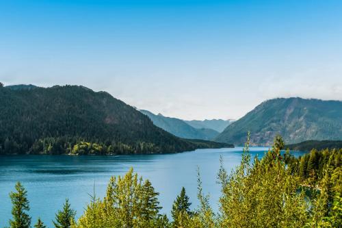 a view of a lake with mountains in the background at Alpine Home in Lilliwaup
