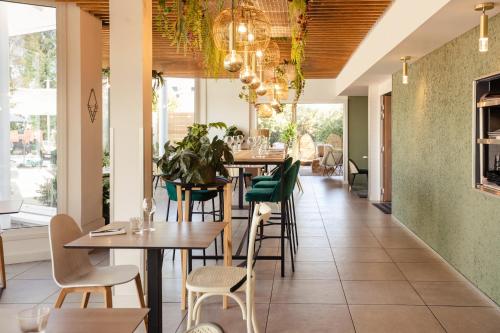a restaurant with tables and chairs and windows at Novotel Nancy in Nancy