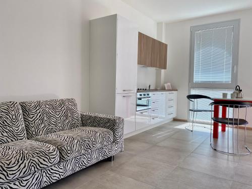 a living room with a couch and a table at Fioralpino Suites in Sospirolo