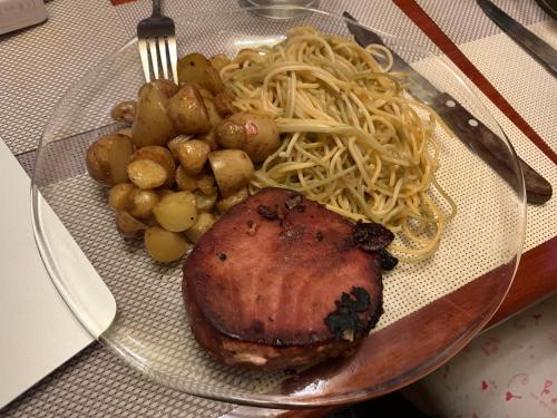 a plate of food with meat and pasta and vegetables at Quinta Maria Bonita Hotel Boutique in Xalapa