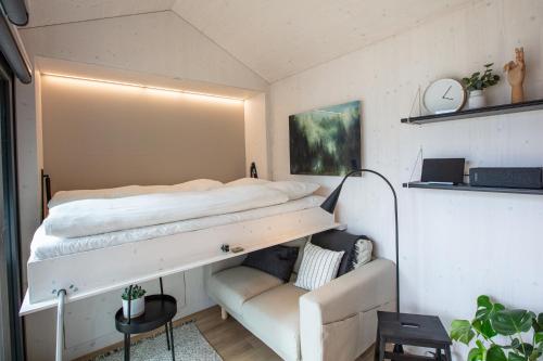 a bedroom with a bunk bed and a couch at Tiny House - Camping Wagenhausen in Wagenhausen