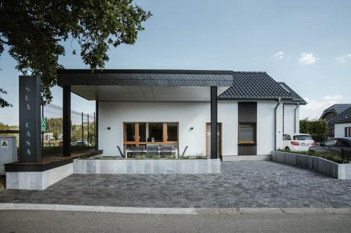 a white house with a black roof at Sua Casa in Amblève