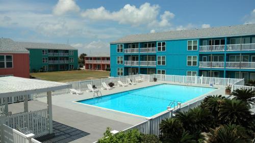 a swimming pool in front of a building at Executive Keys Condominiums on the Beach in Port Aransas