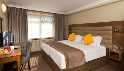 a hotel room with a bed and a desk and a computer at Limerick City Hotel in Limerick