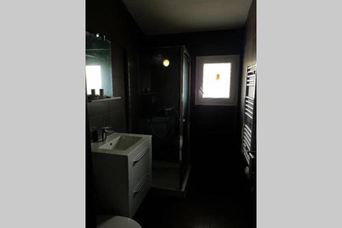 a bathroom with a sink and a toilet and a window at appartement tra mare e monti in Ghisonaccia