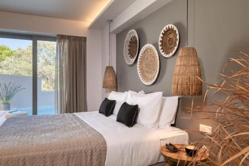 a bedroom with a bed and a large window at Crystal Waters in Nikiana