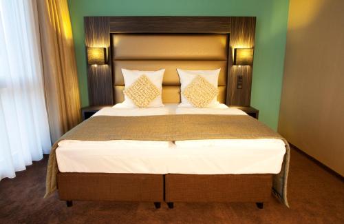 Ein Bett oder Betten in einem Zimmer der Unterkunft Centro Hotel Ayun DELUXE