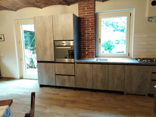 a kitchen with a large refrigerator and a window at LA LEGIUN STRANIERA in Boves