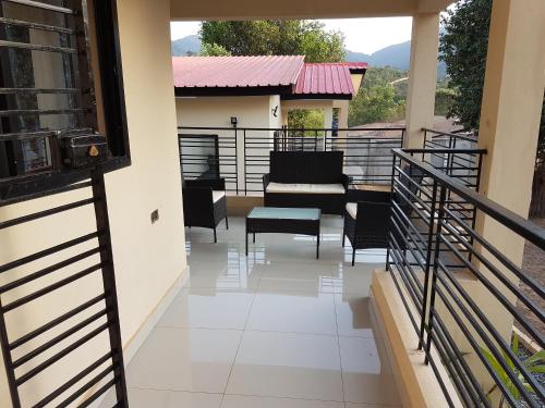 a balcony with a view of a living room at Portersville Private Lodge in Freetown