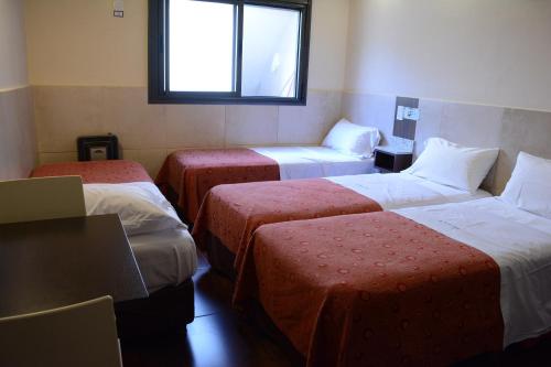 Ένα ή περισσότερα κρεβάτια σε δωμάτιο στο Hotel Santa Cruz