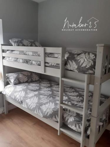 two white bunk beds in a room at Number 25 Self Catering Apartments Ederney in Ardess