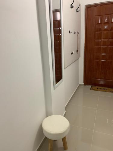 a small bathroom with a stool and a mirror at Sea&Center Lux in Bar