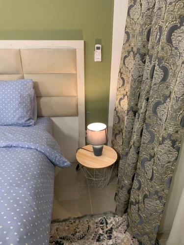 a bedroom with a bed with a lamp on a table at Sea&Center Lux in Bar