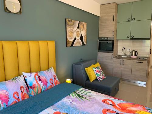 a bedroom with a bed with a yellow headboard and a kitchen at Sea&Center Lux in Bar