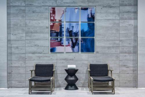 two chairs and a vase in front of a wall at Staybridge Suites - Boston Logan Airport - Revere by IHG in Revere