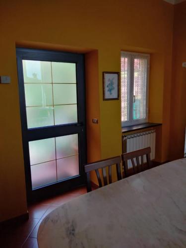 a bedroom with a large bed and a window at Appartamento Oleandro in Montale