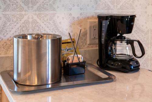a kitchen counter with a mixer and a cup of coffee at The Dorothy Motel in Banff