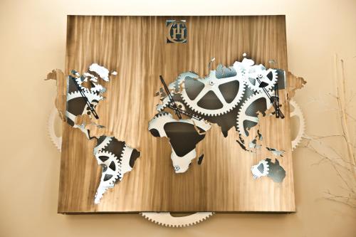 a wooden world map with gears on a wall at Town House Cavour in Reggio Calabria