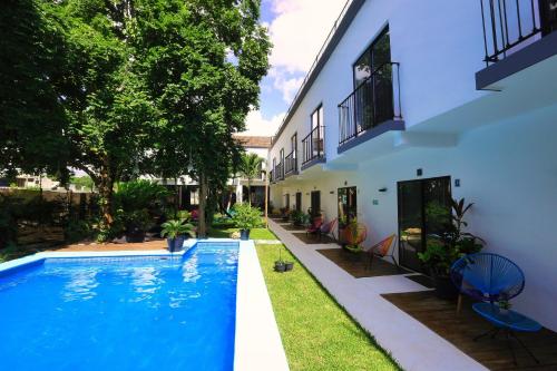 a swimming pool in front of a house at Casa Chukum in Bacalar