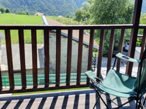 a chair sitting on a porch with a view of a river at Il Rifugio di Marcella in Challand Saint Anselme