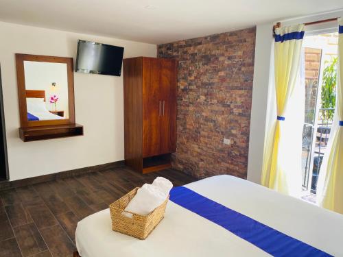a bedroom with a bed and a mirror and a window at Hotel & Suites Cerro Roj0 in Tlatlauquitepec