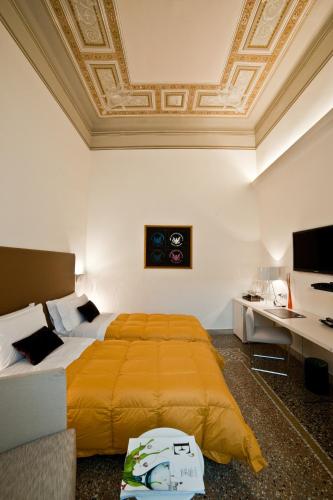 a bedroom with a bed and a coffered ceiling at Town House Cavour in Reggio Calabria
