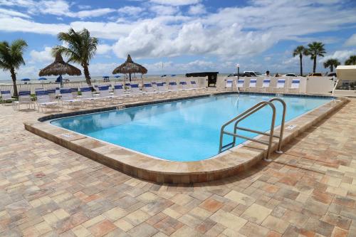 a swimming pool with a stairway leading to a resort at 310 Beach Place Condos in St. Pete Beach