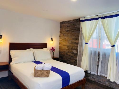 a bedroom with a bed with two baskets on it at Hotel & Suites Cerro Roj0 in Tlatlauquitepec