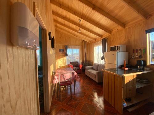 a kitchen and living room of a house at Cabaña Puerto Sánchez RYS Patagonia A in Puerto Sanchez