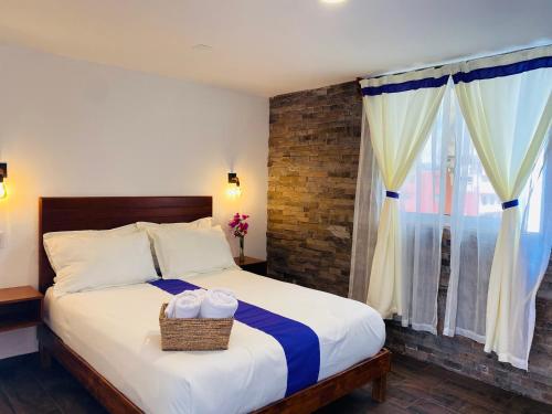 a bedroom with a bed with a basket on it at Hotel & Suites Cerro Roj0 in Tlatlauquitepec