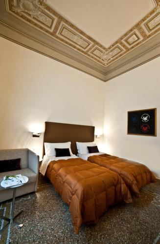 a bedroom with a large bed and a couch at Town House Cavour in Reggio Calabria