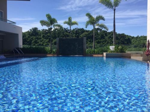 a large swimming pool with blue water at Belmont Hotel Boracay near Newcoast Beach in Boracay