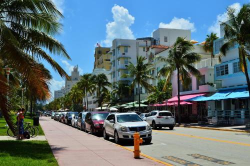 a city street with cars parked on the side of the road at Penthouse De Soleil South Beach - on Ocean Drive Miami Beach in Miami Beach