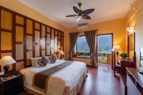 a bedroom with a large bed and a large window at Chau Long Sapa 2 Hotel in Sapa