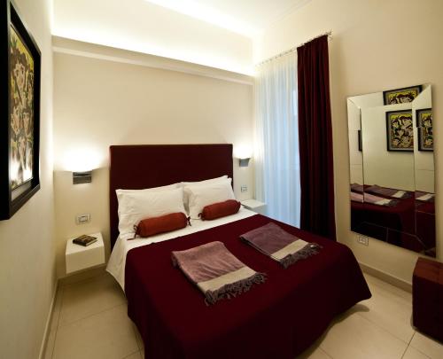 a bedroom with a large bed with two towels on it at Town House Cavour in Reggio Calabria