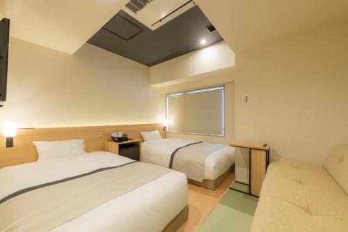 Posteľ alebo postele v izbe v ubytovaní Tosei Hotel Cocone Ueno Okachimachi