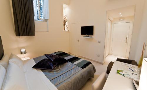 a bedroom with a bed with pillows on it at Town House Cavour in Reggio Calabria