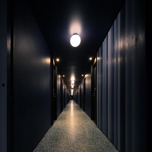 a long corridor with a light at the end of a tunnel at Seamira House Huahin in Hua Hin