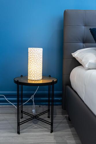 a table with a lamp on it next to a bed at ESCAPE time - Paris in Gentilly