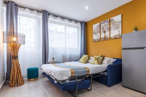 a bedroom with a bed and a large window at ESCAPE time - Paris in Gentilly