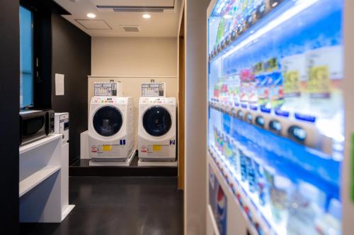 a row of washing machines in a store at Tosei Hotel Cocone Ueno Okachimachi in Tokyo