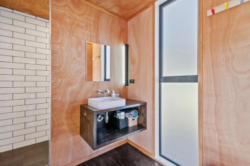 a bathroom with a sink and a mirror at The Waikato Lookout - Whakamaru Holiday Home in Mangakino