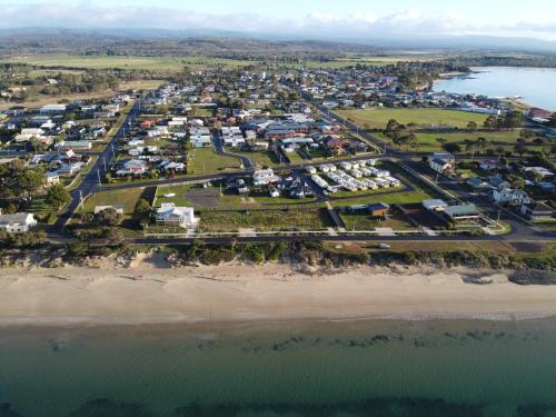 an aerial view of a resort next to the beach at Swansea Holiday Park Tasmania in Swansea