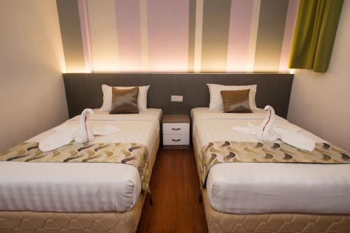 Ένα ή περισσότερα κρεβάτια σε δωμάτιο στο Yan Hotel