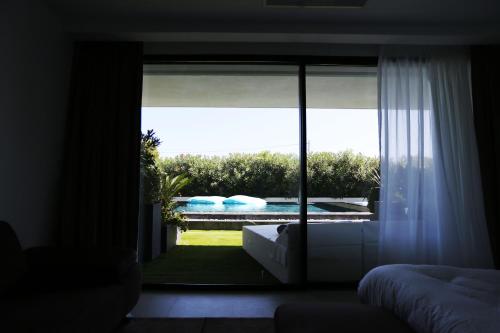 a room with a window with a view of a pool at VILLA MIAMI in Les Issambres