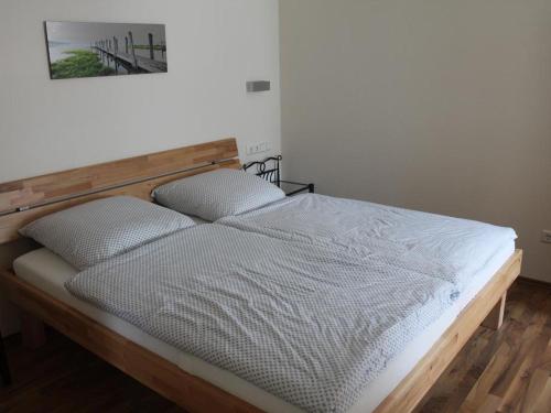 a bed with two pillows on it in a room at Apartments Kuhlmann in Saalhausen